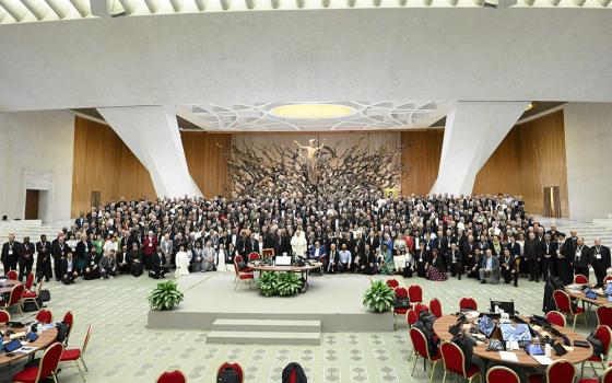 Pope Francis poses for a photo with participants in the assembly of the Synod of Bishops before a working session in the Paul VI Audience Hall at the Vatican Oct 23. (CNS/Vatican Media)